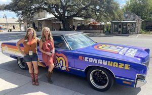 dripping-springs-marketing-built-to-last Dee Marsh and Dana Mihaly beside a vintage car at a Dripping Springs event